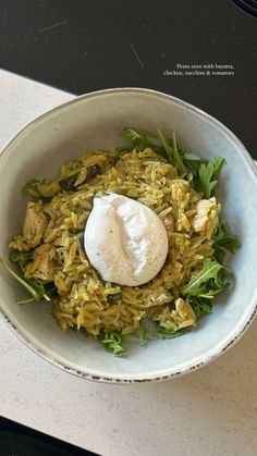 a white bowl filled with food on top of a counter