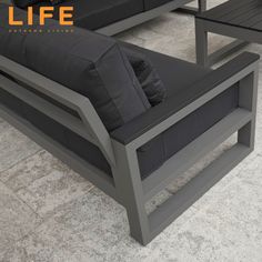 a couch and table sitting on top of a tile floor next to each other with the words life written above it