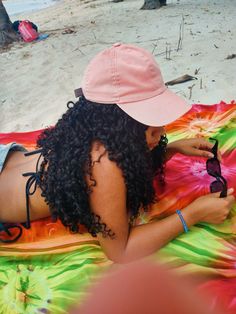 a woman laying on top of a colorful blanket