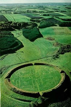 an aerial view of a large green field