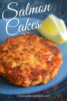 salmon cakes on a blue plate with lemon wedges in the background and text overlay that reads salmon cakes