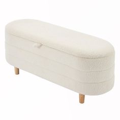 a white upholstered bench with wooden legs and footrests on an isolated white background