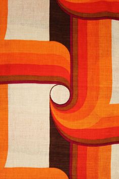 an orange and brown abstract design on fabric