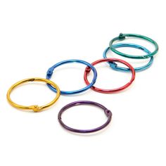 four different colored metal bracelets on a white background with clipping in the middle