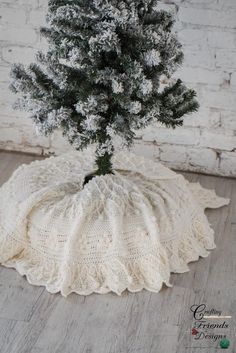 a knitted tree cover sitting on top of a wooden floor