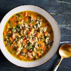 a white bowl filled with chicken and vegetable soup