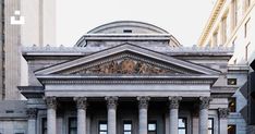 an old building with columns and pillars in front of it