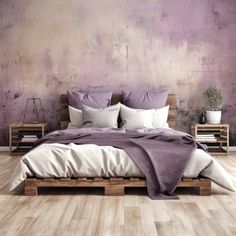 a large bed sitting next to a purple wall