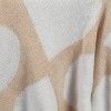 a close up view of a white and beige shirt with circles on the fabric,