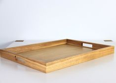 a wooden tray sitting on top of a white table