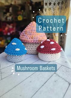 three crocheted mushrooms sitting on top of a table