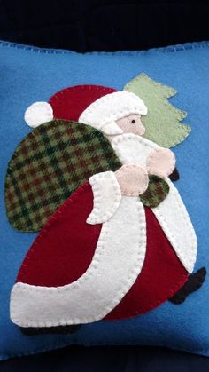 a blue pillow with a santa clause on it