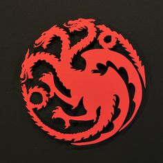 a red and black dragon symbol on a black background