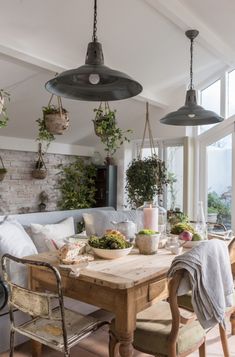 a wooden table topped with lots of plants and potted plants on top of it