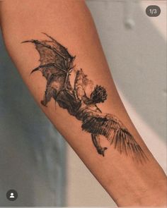 a tattoo on the arm of a woman with a dragon flying over her head,