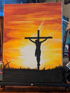 a painting of a person with a cross in front of an orange and yellow sunset