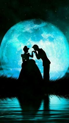 the silhouettes of two people are standing in front of a full moon and water