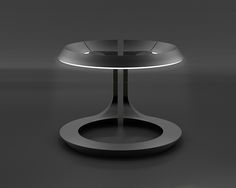 a round table with an illuminated base on the top, in black and grey tones