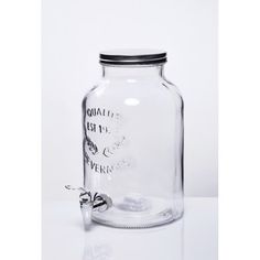 a clear glass jar with a metal clip on the top and an empty bottle in the bottom