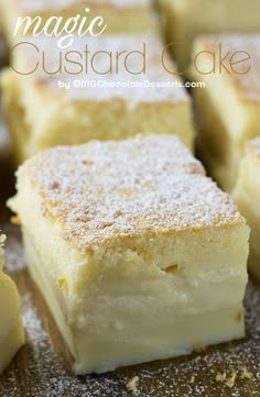 several pieces of cake sitting on top of a wooden table covered in powdered sugar