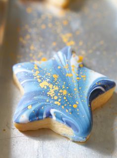 a blue and white star shaped cookie sitting on top of a table