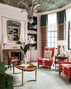 a living room filled with furniture and a fire place next to a window covered in curtains