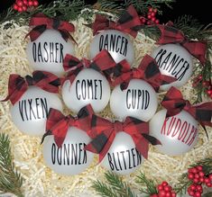 christmas ornaments with names and bows on them