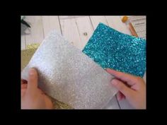 someone is cutting out glitter paper to make something blue and silver on the floor with scissors