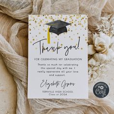 graduation thank you card with gold confetti and black cap on it, surrounded by flowers