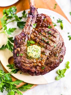 the steak is ready to be served on the plate with parsley garnish