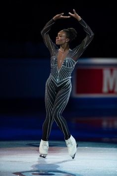 a female figure skating on an ice rink