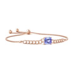 This stylish curb chain bracelet in 14k rose gold features a cushion tanzanite in prong setting. The solitaire gemstone captures the eye with its stunning bluish violet hue. This bolo bracelet is adjustable to fit most wrists. Tanzanite Bracelet, Curb Chain Bracelet, Bolo Bracelet, Aquamarine Bracelet, March Birthstone Jewelry, Natural Aquamarine, March Birth Stone, Curb Chain, Adjustable Bracelet