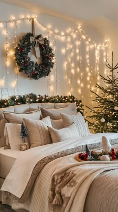 a bedroom decorated for christmas with lights on the headboard and wreath above the bed