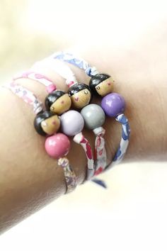 a woman's arm with several bracelets on it