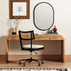 a desk with a mirror and chair in front of it