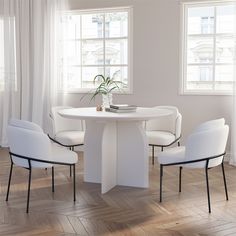 a white table with four chairs around it