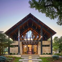 the front entrance to a home with stone steps leading up to it and an open porch