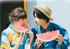 two people eating slices of watermelon on a sunny day