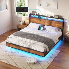 a bed that has some lights on the headboard and foot board in front of it