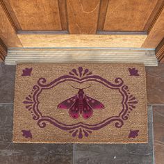 a door mat with a purple moth on it