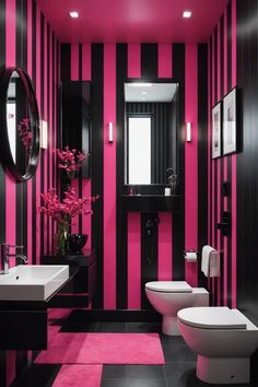 a bathroom with black and pink stripes on the walls, white toilet and bidet