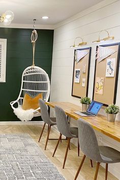 a room with chairs, a rug and a laptop on the table in front of it