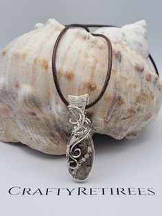 Embrace the natural beauty of Wild Horse Jasper with this stunning pendant, expertly wire-wrapped in sterling silver. Known for its earthy tones and unique patterns, Wild Horse Jasper is a gemstone that exudes warmth and grounding energy. This pendant showcases the stone's distinctive blend of brown, cream, and gray hues, making it a perfect accessory for those who love nature-inspired jewelry. Jasper's Unique Qualities: Wild Horse Jasper is celebrated for its grounding properties and connection Nature-inspired Sterling Silver Wire Wrapped Jewelry, Nature-inspired Sterling Silver Wire Wrapped Necklaces, Nature-inspired Wire Wrapped Sterling Silver Necklaces, Wire Wrapped Ocean Jasper Pendant Jewelry, Sterling Silver Brown Wire Wrapped Jewelry, Rock Tumbling, Grounding Energy, Earthy Jewelry, Rock Jewelry