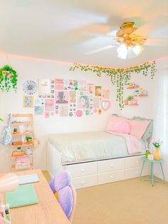 a child's bedroom with pink and green decor on the walls, white bedding and wooden desks