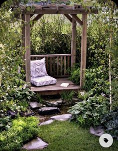 a wooden bench sitting in the middle of a garden