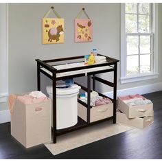 a baby changing table with two bins on the bottom and three storage baskets below it