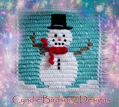 a crocheted snowman with a top hat and scarf