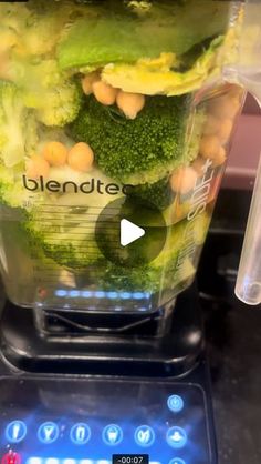 a blender filled with broccoli and chickpeas