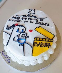 a white cake with yellow and blue frosting on it's side that says, 24 de mayos enamor en la basura