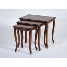 three wooden nesting tables sitting on top of each other